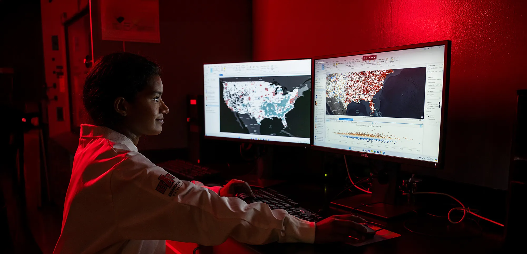 researcher in front of two computer screens