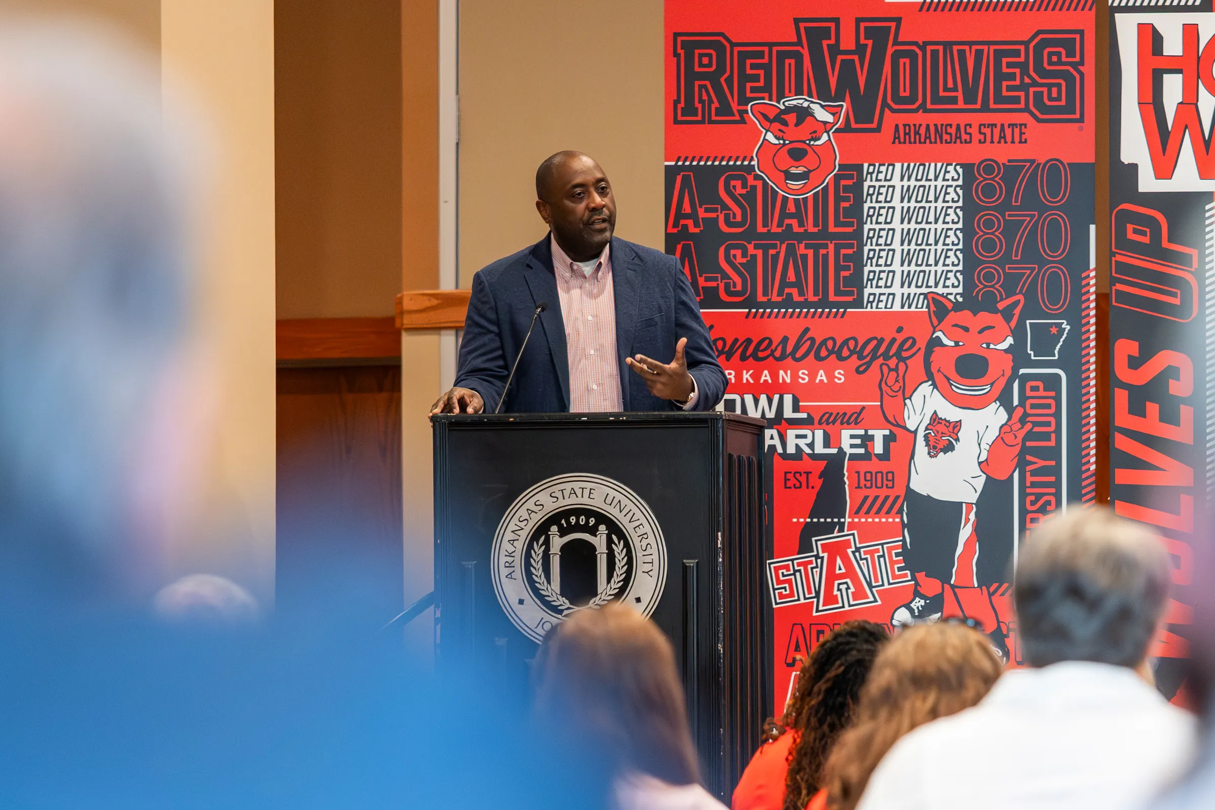 Dr. Calvin White addresses faculty and staff from the podium.