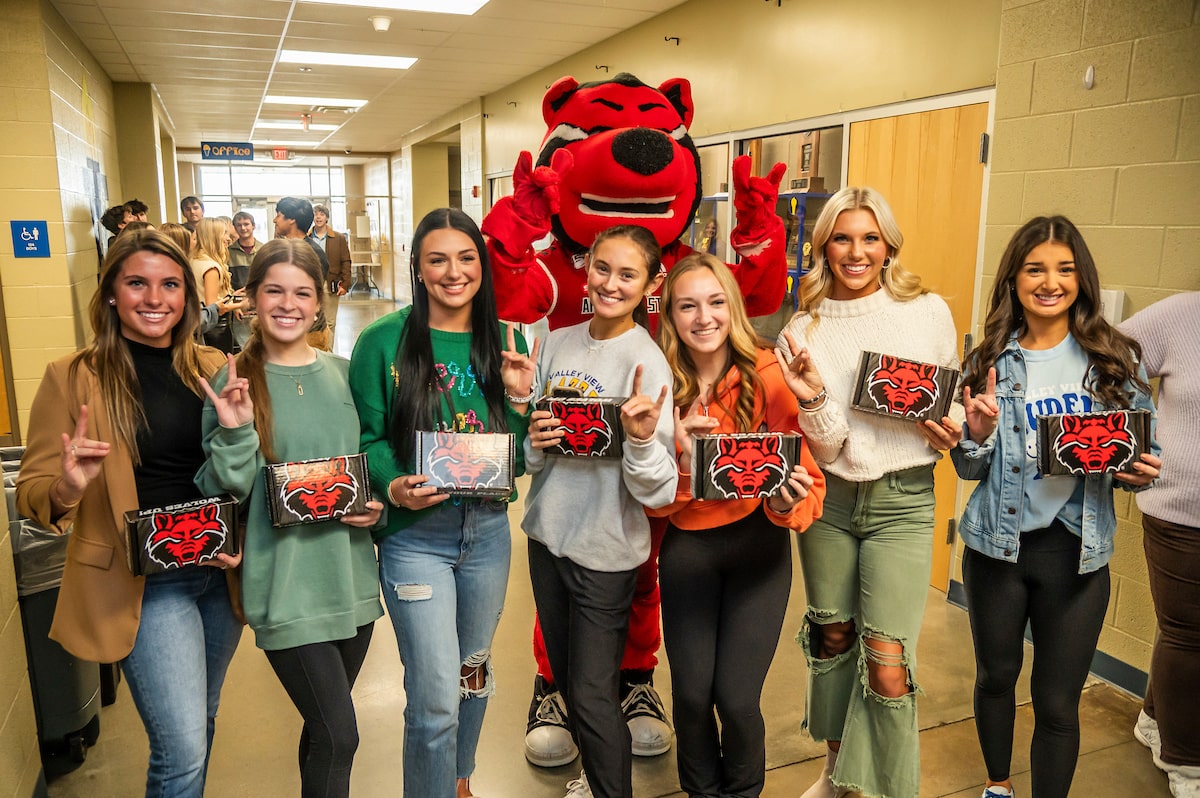 Students gather in the hallway of Valley View High School to celebrate their admission boxes from A-State