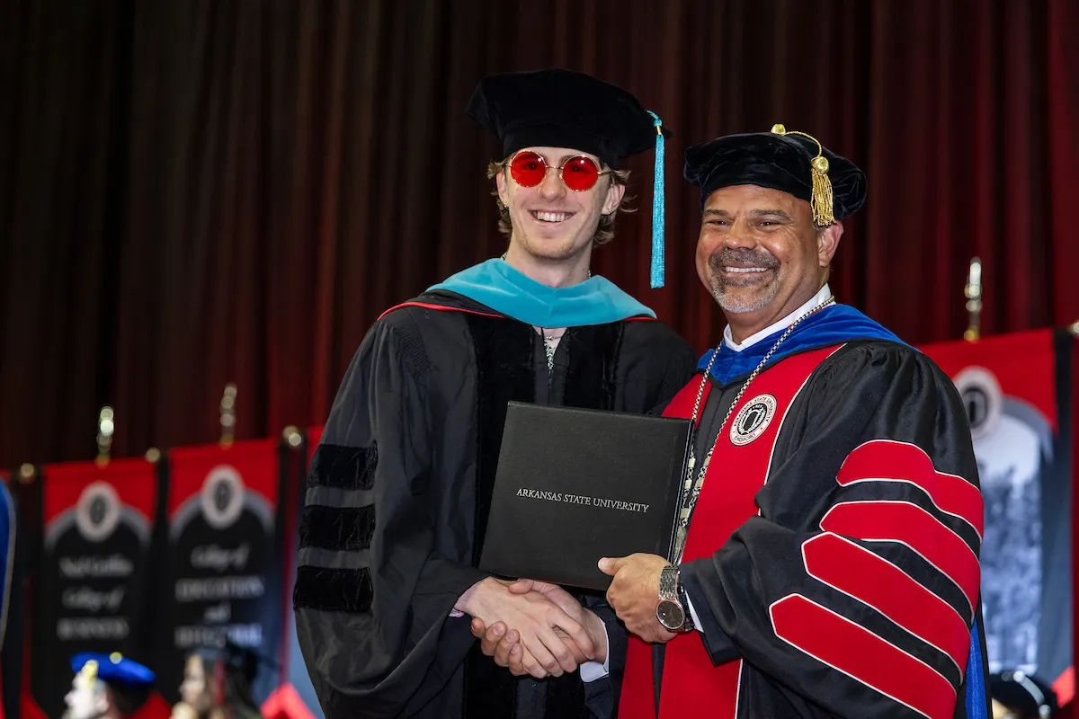 Chancellor Todd Shields awards a graduate degree at a recent commencement ceremony.