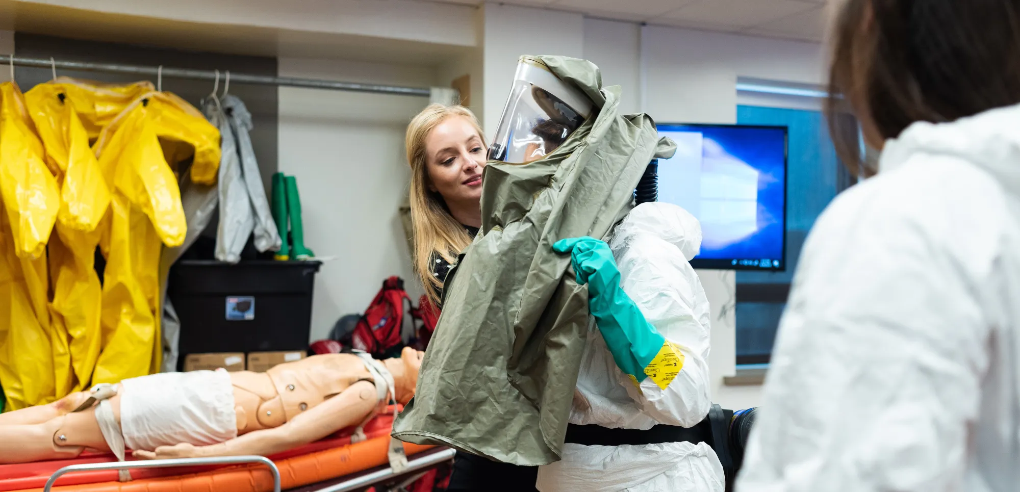 Students putting on hazmat suits with Dr. Hymen in class.