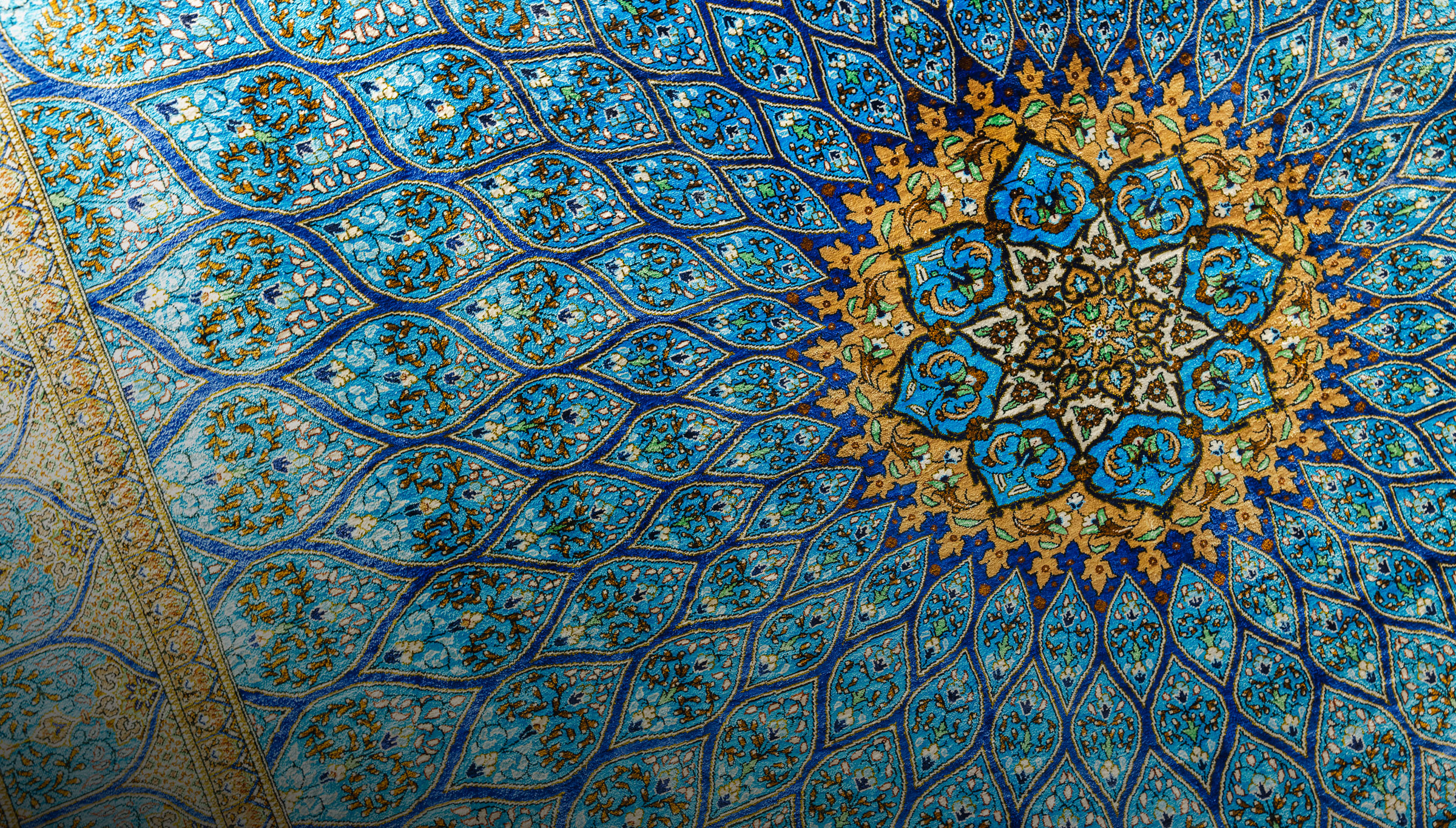 Oriental silk carpet with circular pattern, close-up photo