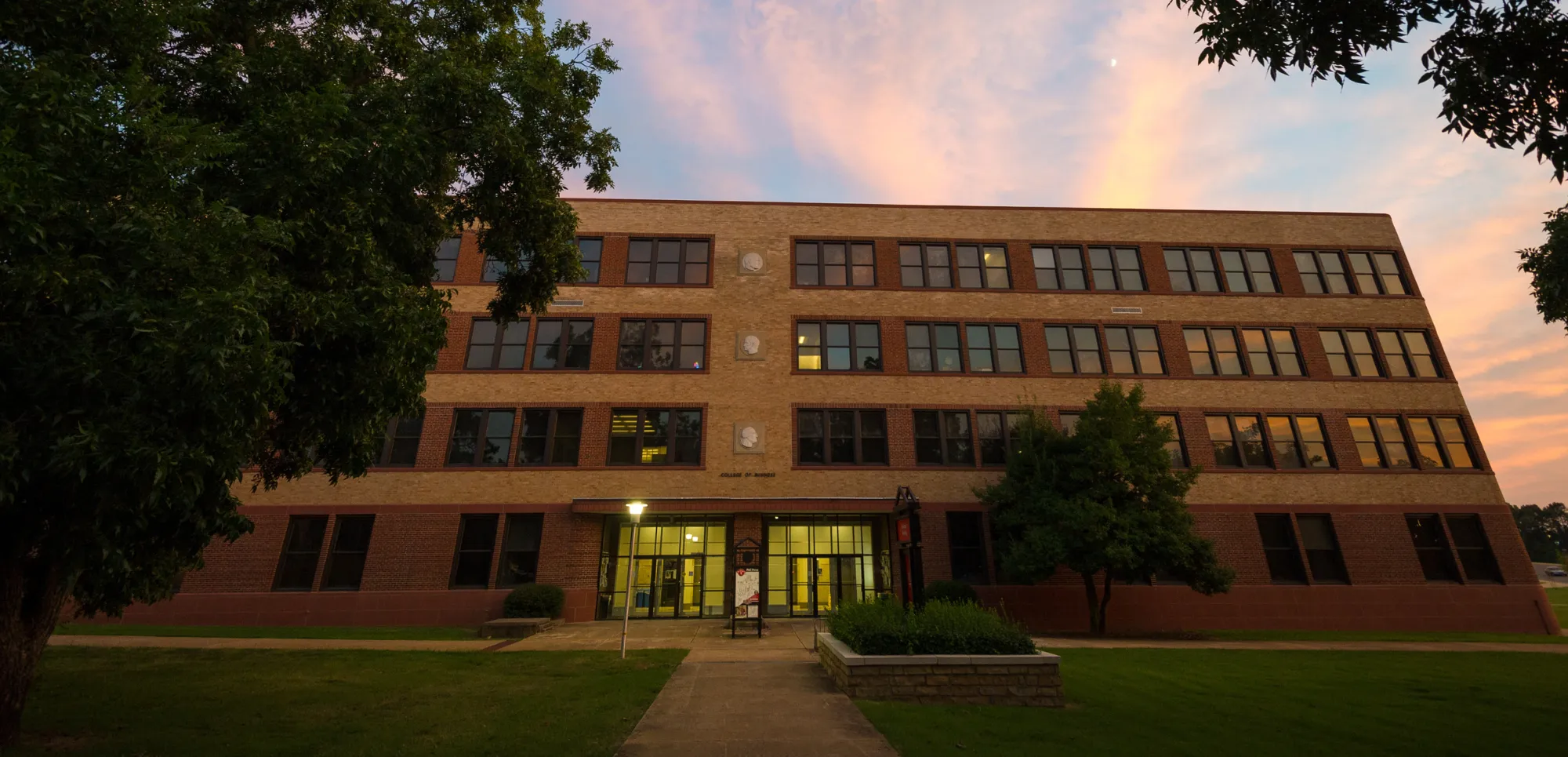 Neil Griffin College of Business during the golden hour with landscaping.
