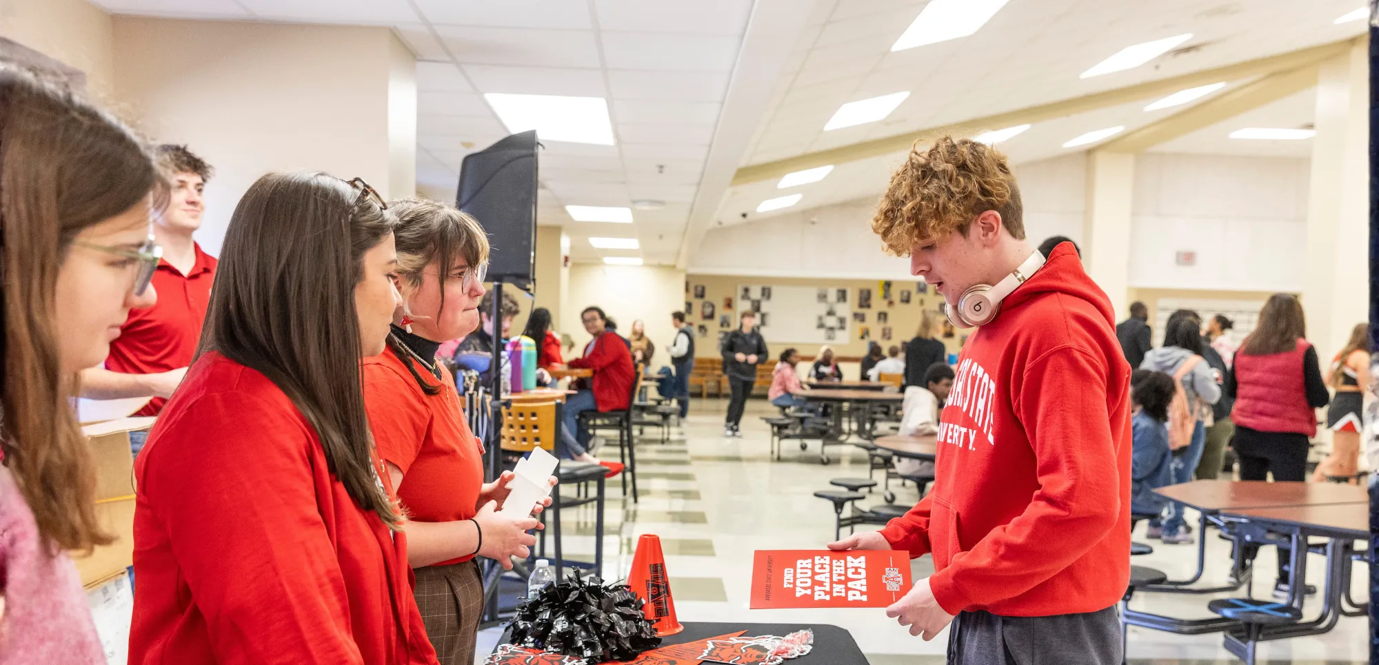 A-State faculty and staff at a high school in Jonesboro interacting with students.