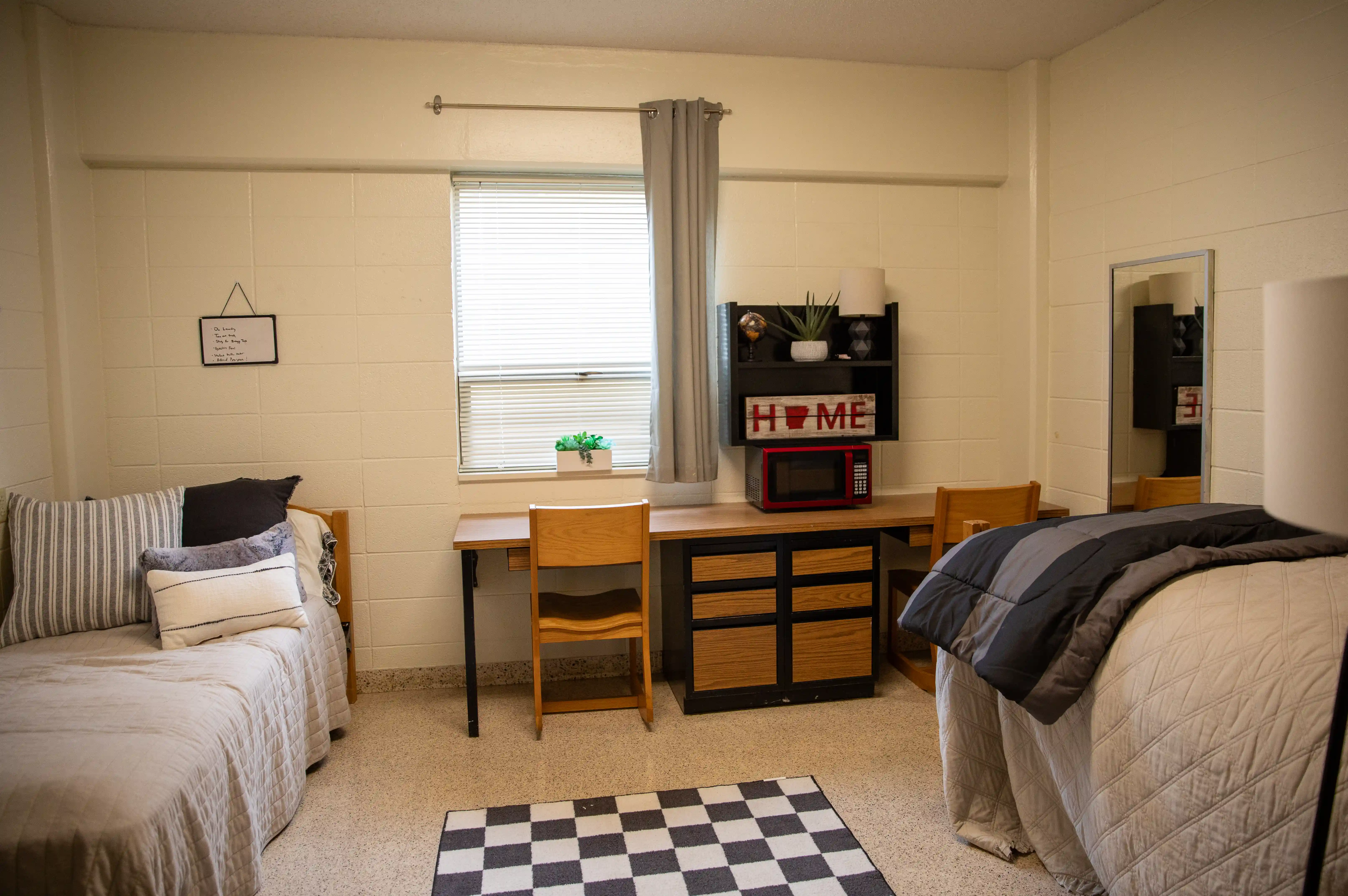 Kays Hall bedroom showing two twin beds and desk with two chairs.