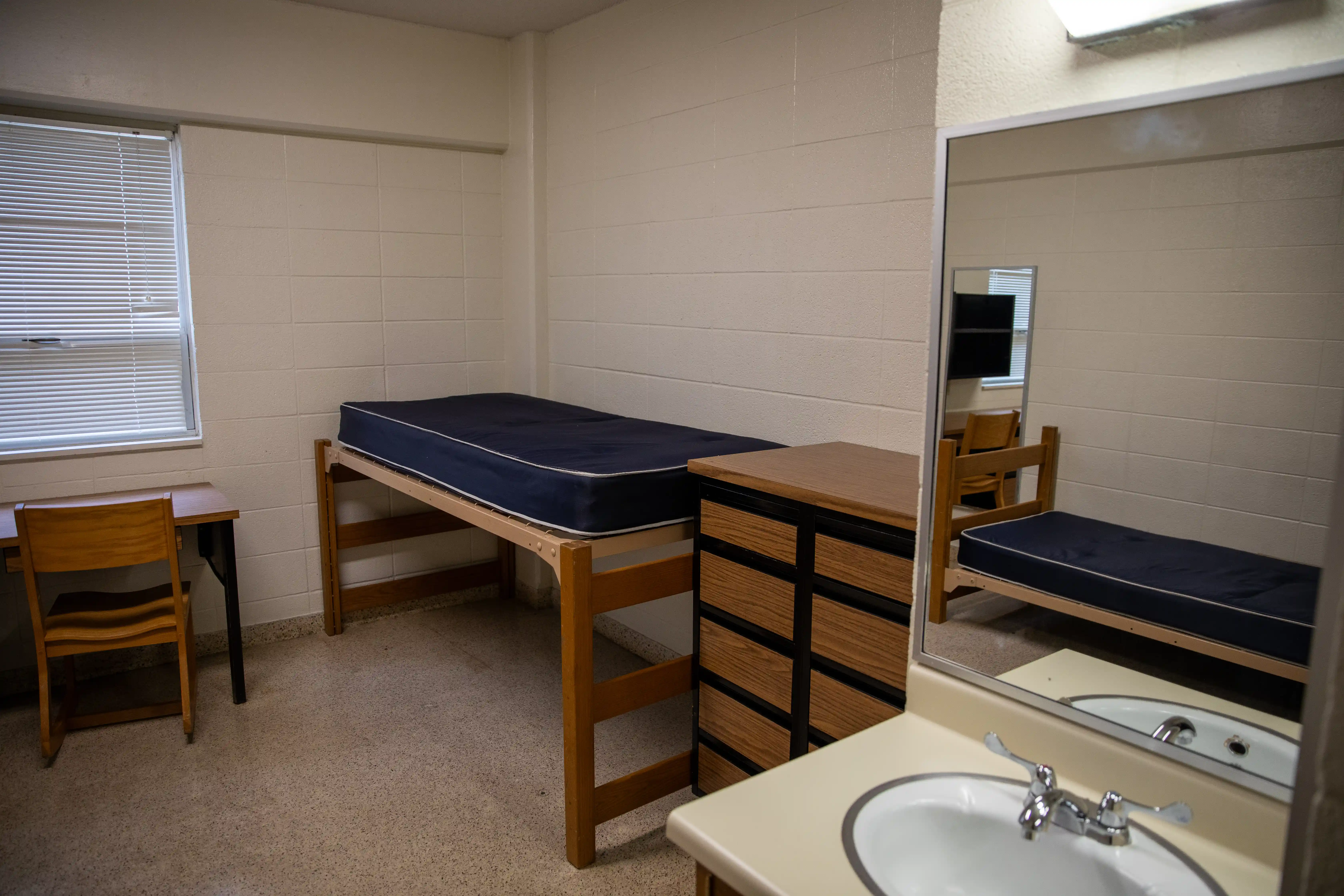 Bed, desk, and dresser in Kays Hall room.