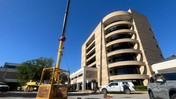 Crane pictured outside of Dean B. Ellis Library