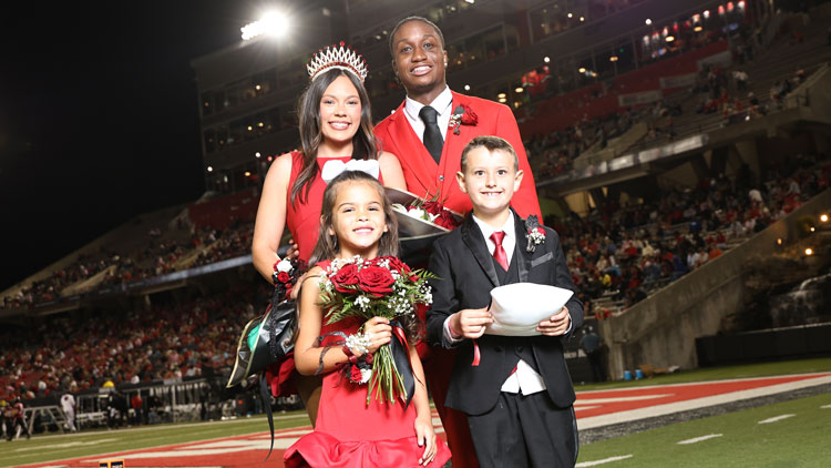 Homecoming queen Emma Dorton and Homecoming king Cosmo Deveaux stand with Little Mister A-State Harris McDaniel and Little Miss A-State Nora Lorick. 