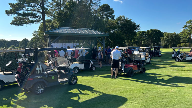 People participating in golf tournament.