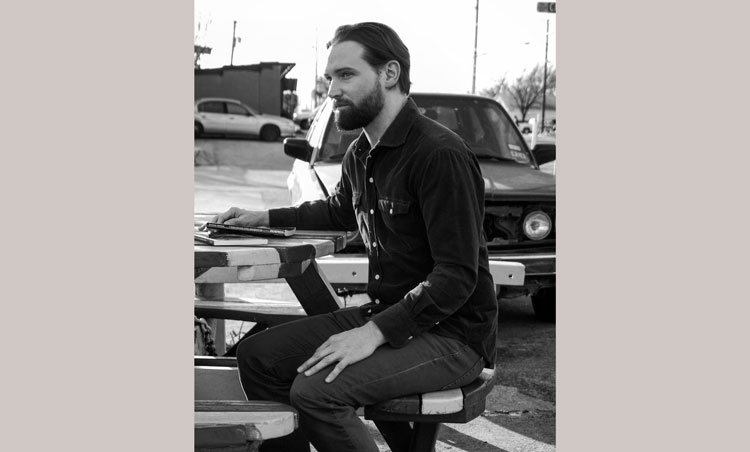 photo of a man at a picnic table