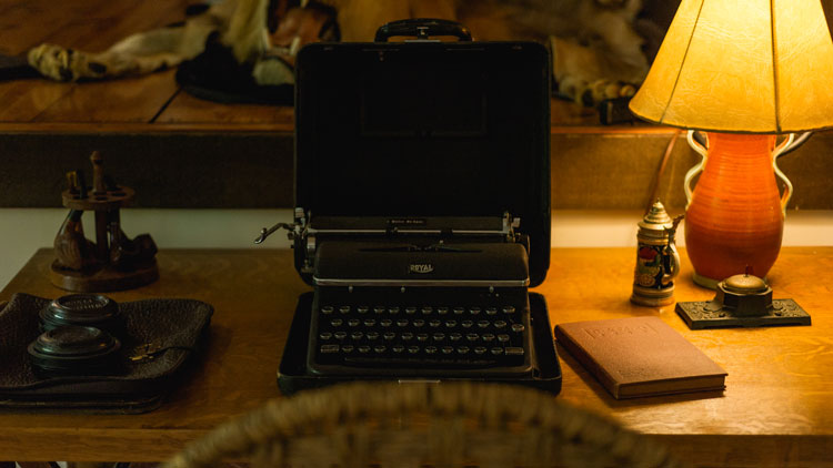 typewriter ona table with a lamp 