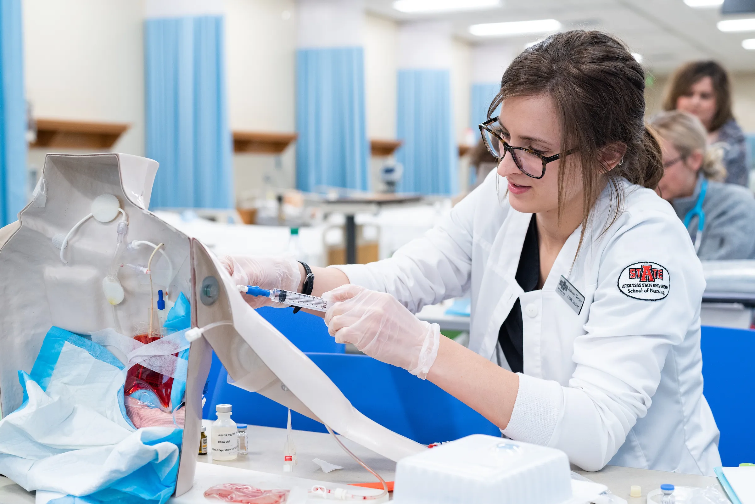 An A-State nursing student practices hands-on clinical skills during a simulation lab exercise.