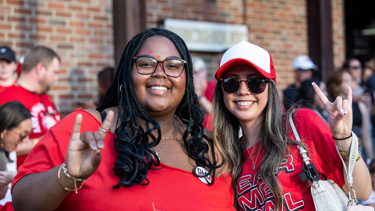 two women wearing red make the 