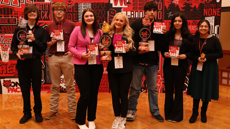Students holding trophies