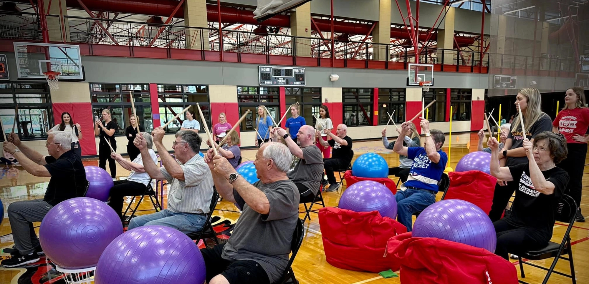 Occupational Therapy event with patients drumming excitedly.
