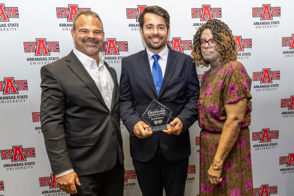 Business student in class getting help from instructor.