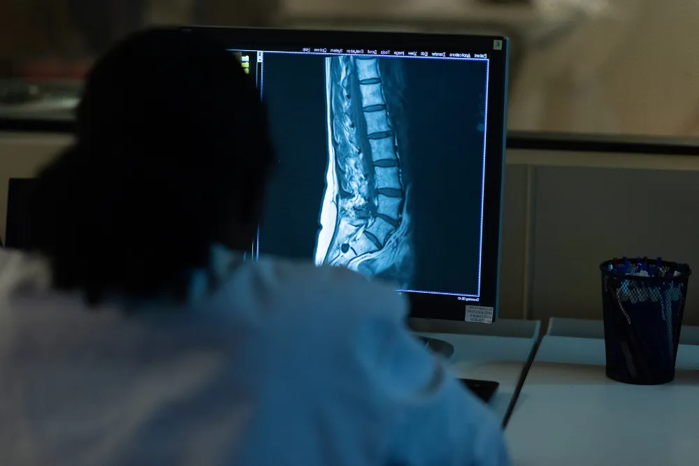 Student going over MRI results on a spine.
