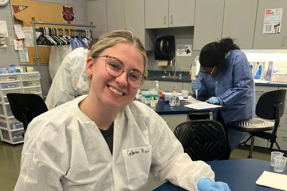 Clinical Lab student smiling at the camera in lab science classe.