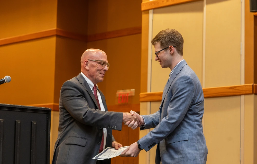Dr. Doering giving an award to a student