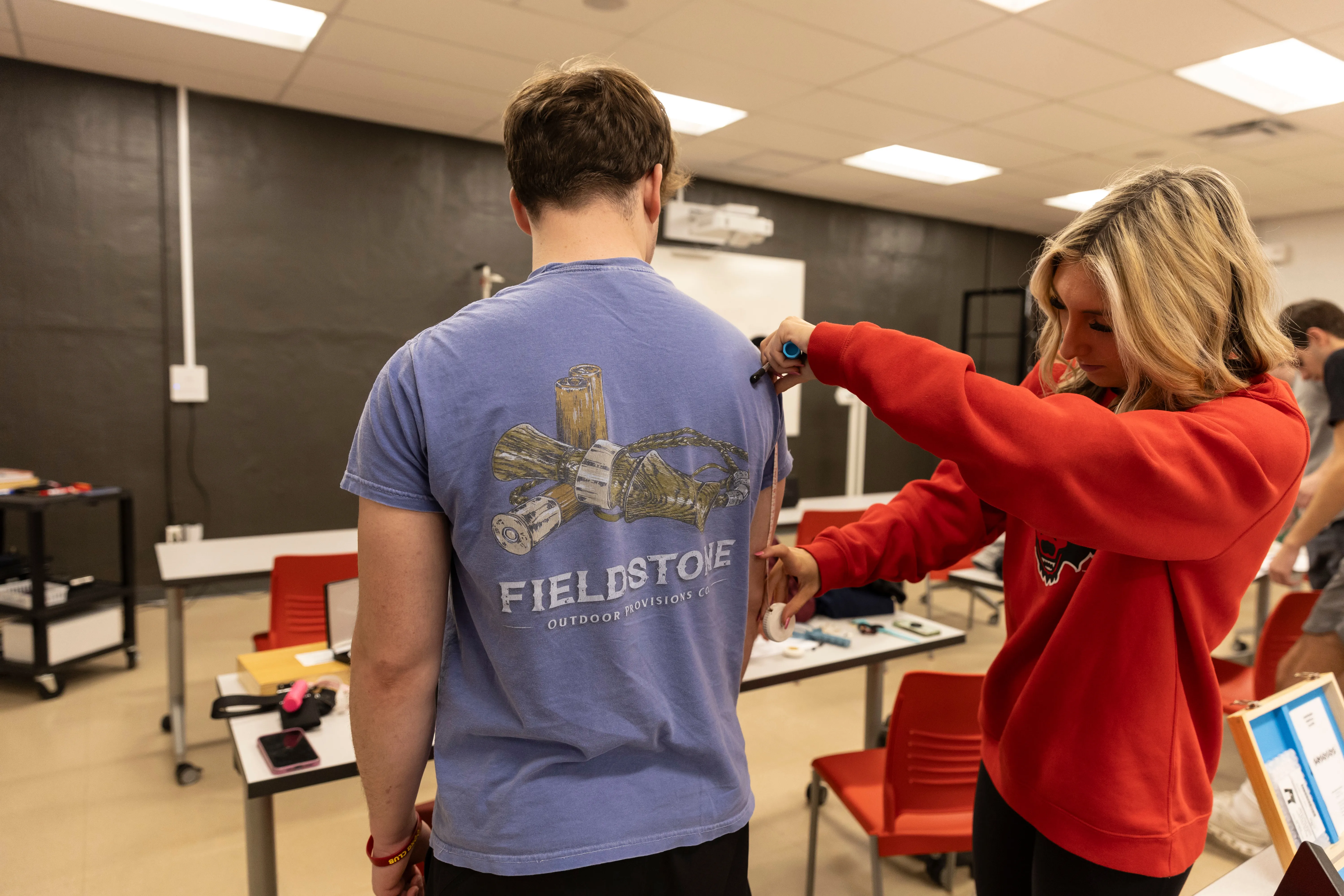 Physical therapy students running test simulations on computer.