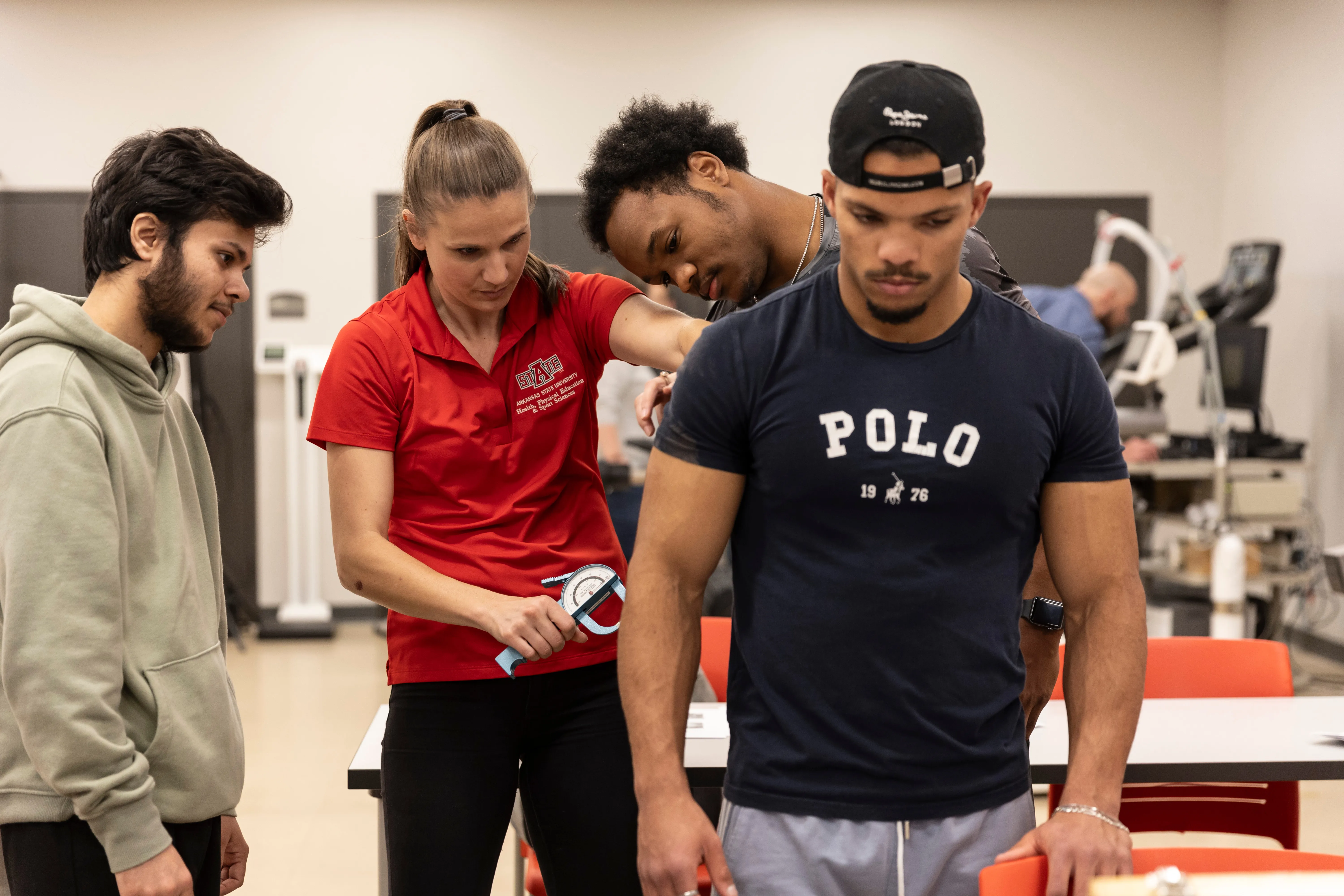 Physical Therapy students working on each other in class.
