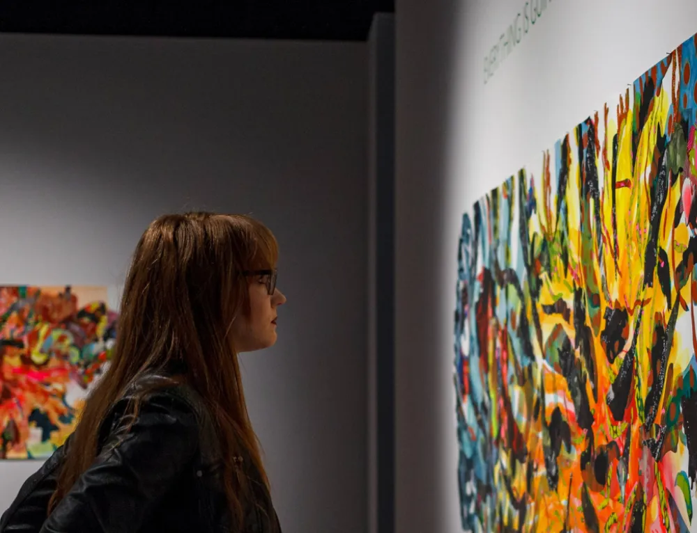 A person in the Bradbury Art Museum looking at an abstract painting
