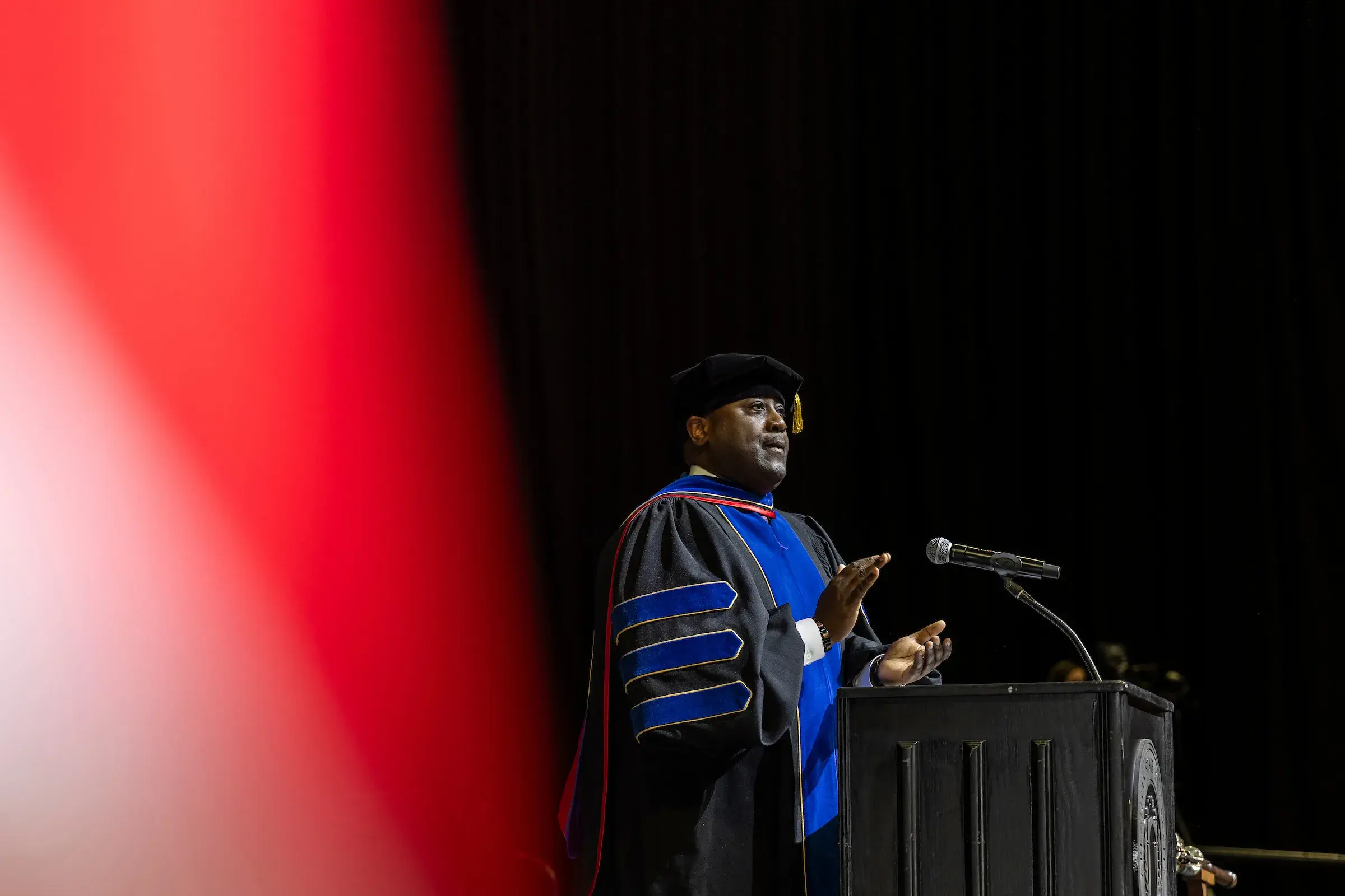 Provost White claps for the graduates at a recent commencement ceremony