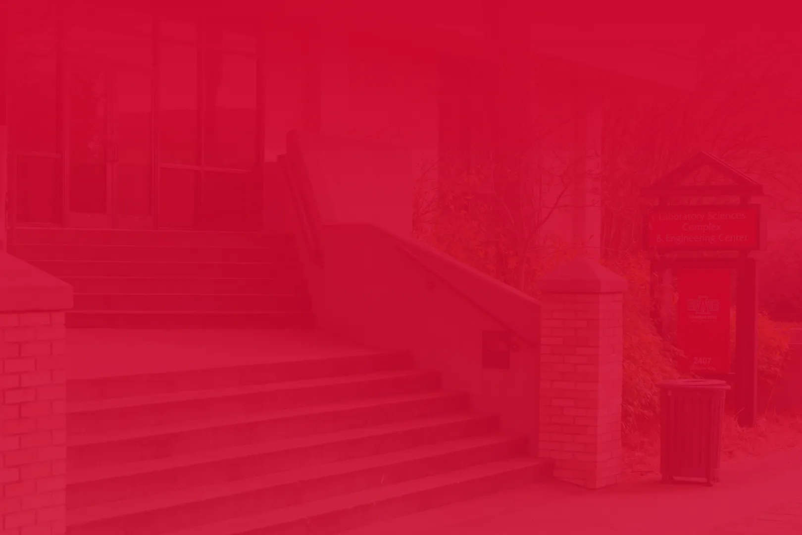 Engineering and Computer Science building up close at the stairs with a sign of the building in view.