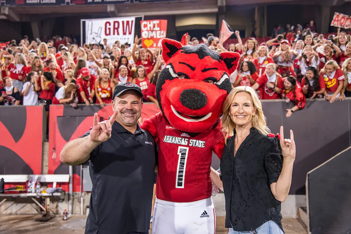 Chancellor Todd Shields and his wife Karen stop to take a photo with Howl and hundreds of A-State students at Order of the Pack.