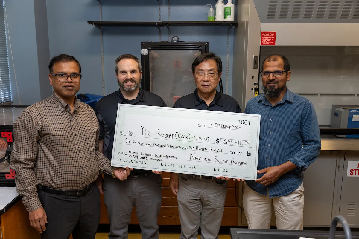 Faculty researchers present large check for National Science Foundation grant.