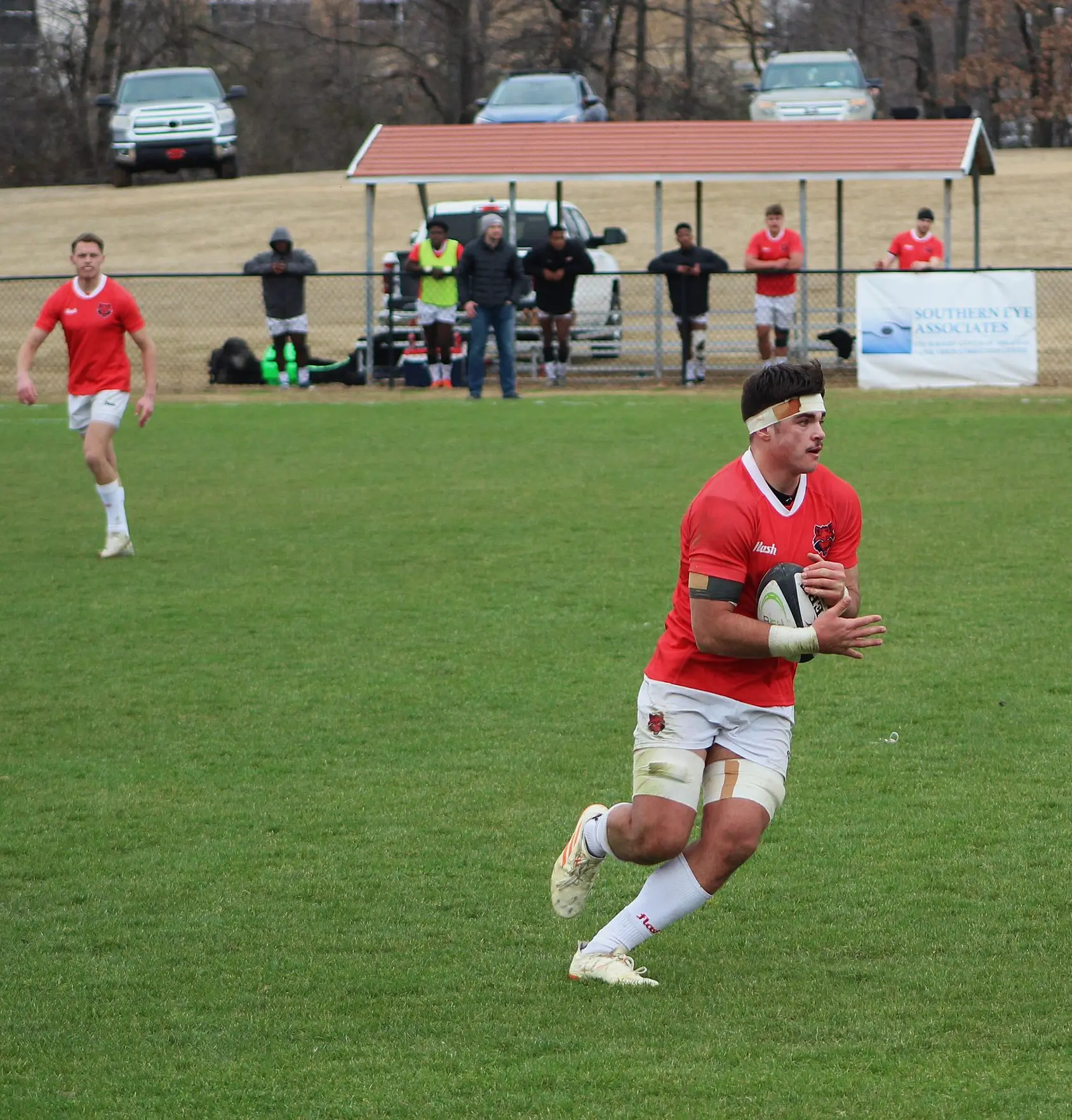 Rugby player running down field at the Curt Huckaby rugby pitch.