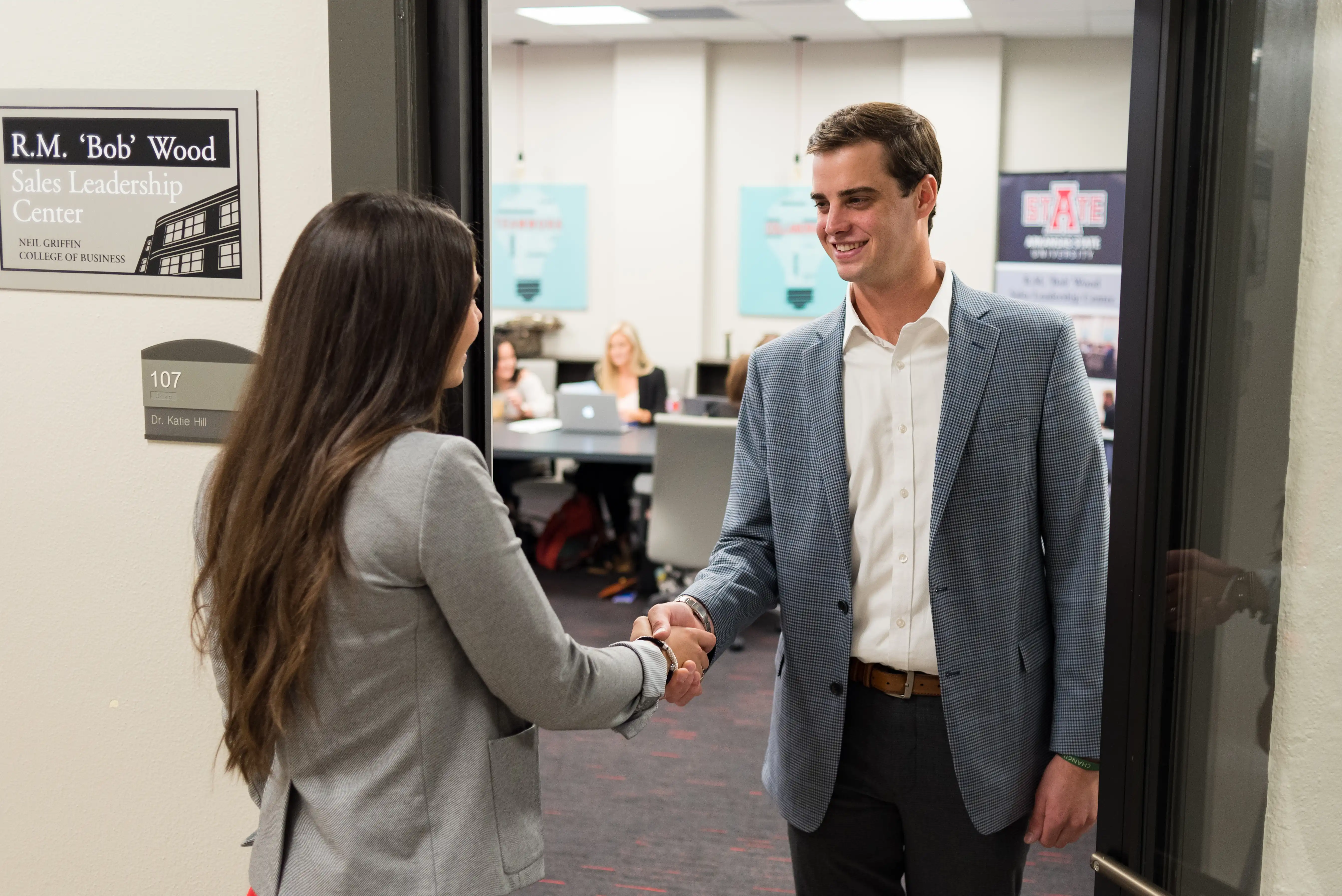 sales leadership center with students shaking hands during mock interviews.
