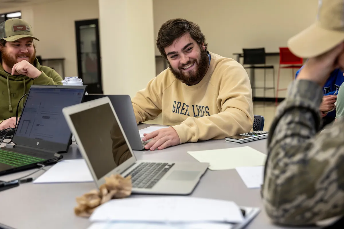 A group of A-State students sit around a table to study for an upcoming exam.