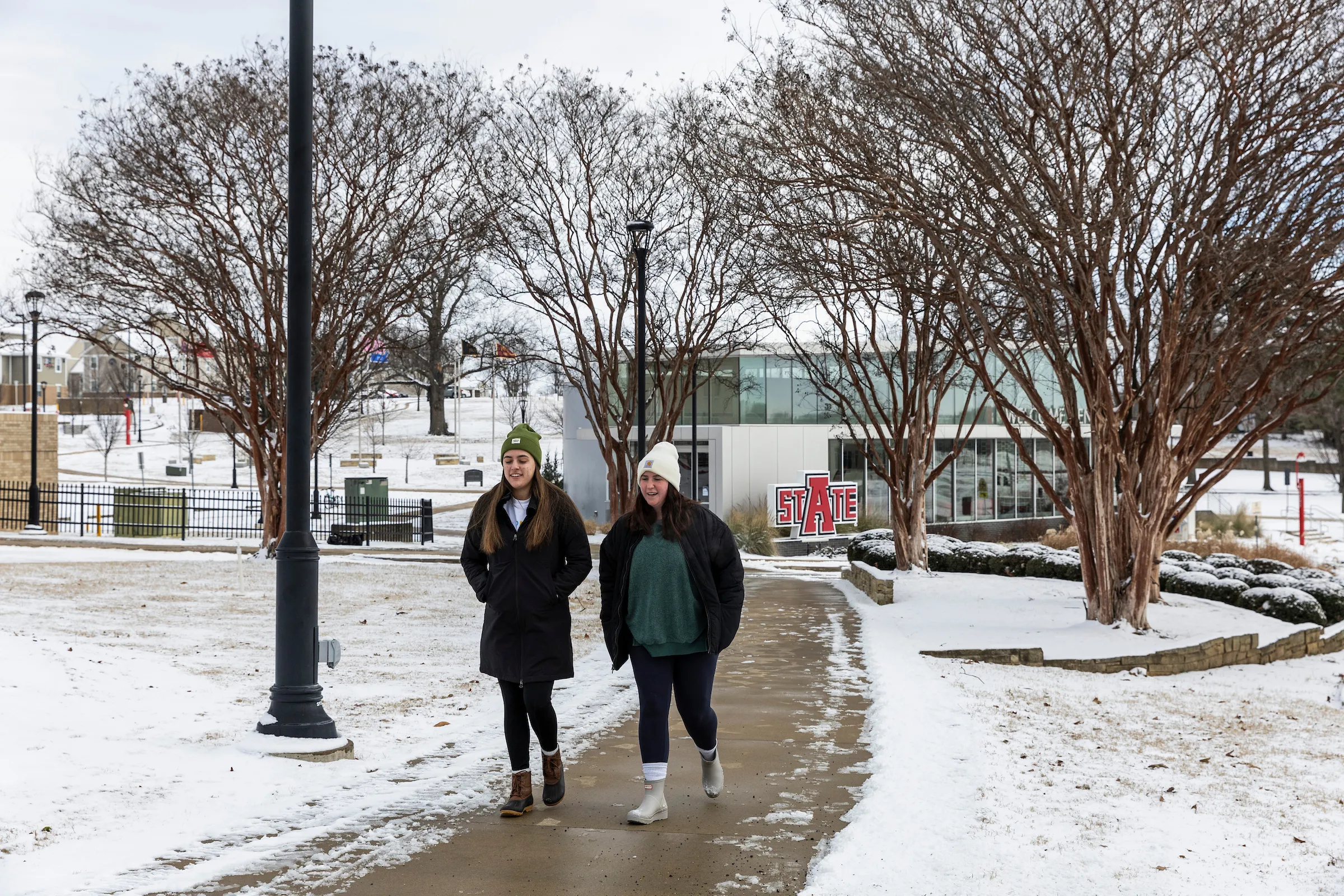 A student checks his phone during a snow storm on campus.