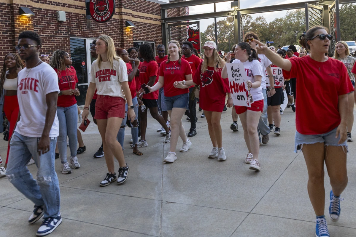 Students walking through the entrance to the Order of the Pack