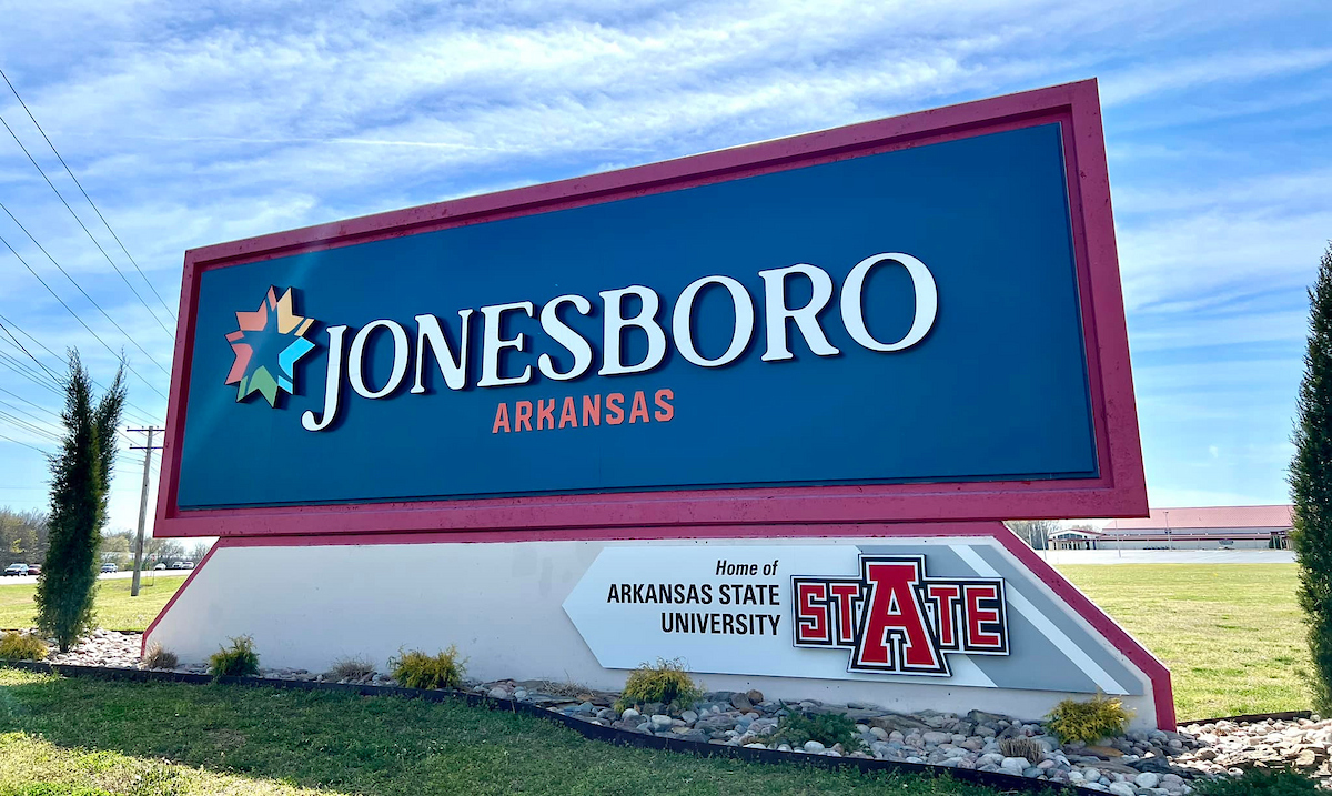 Colorful welcome sign for Jonesboro, Arkansas, highlighting it as home of Arkansas State University.