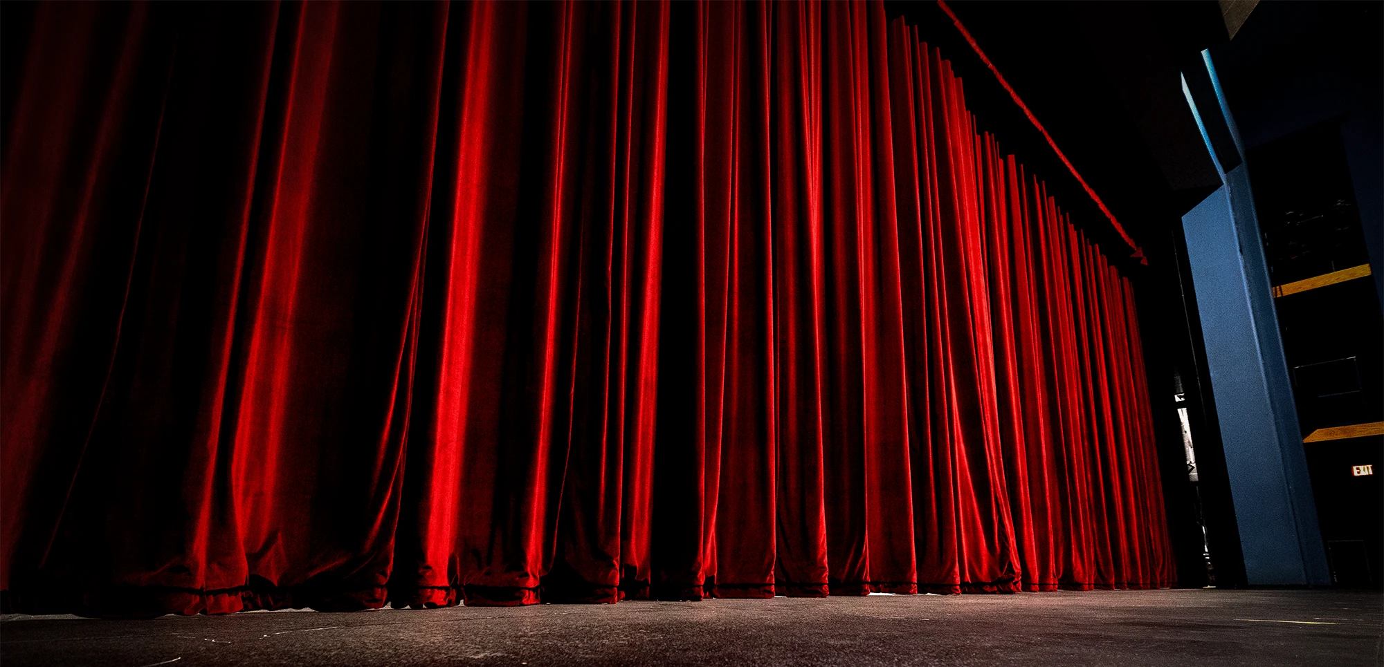 A close-up of a red curtain and stage at Fowler Center.