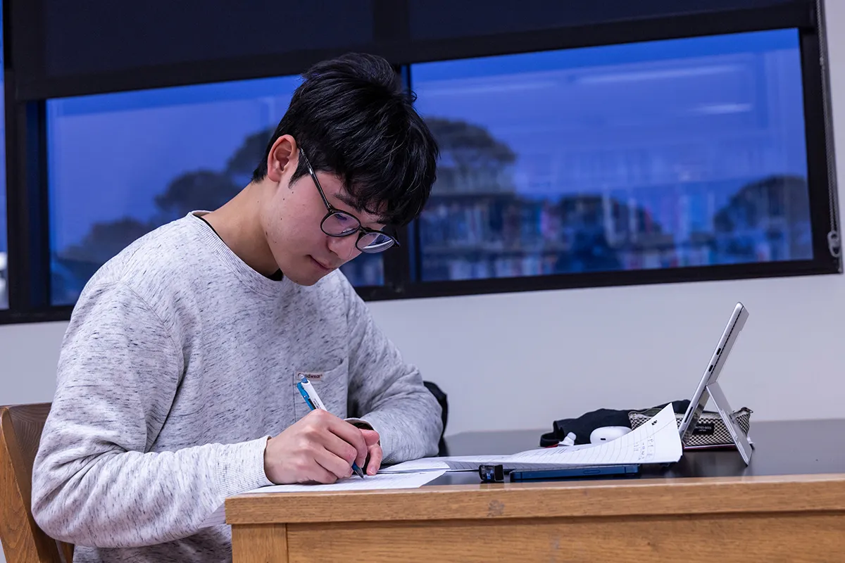 An A-State student works on an assignment in the library.